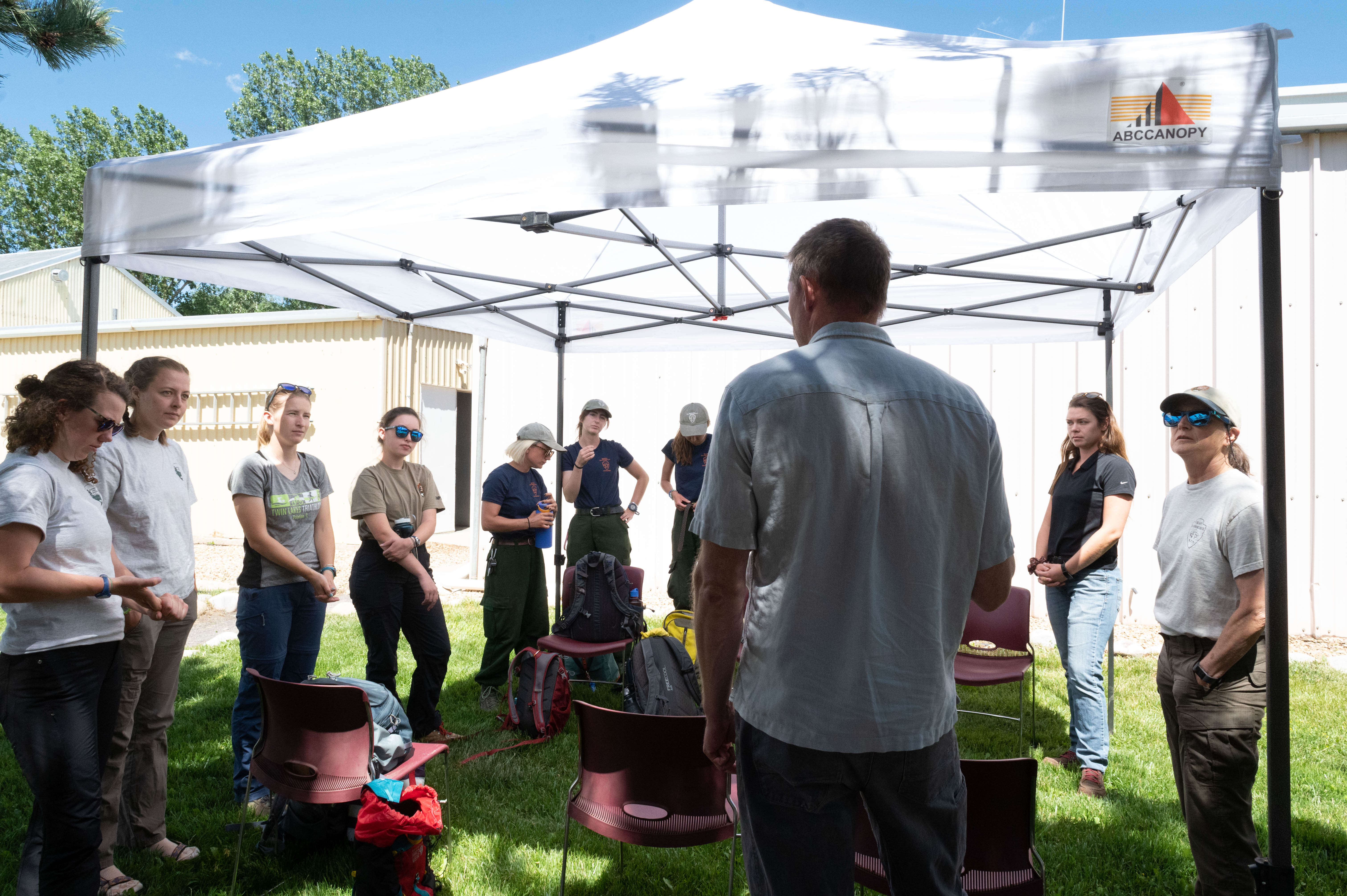 An NMSU Faculty member talking with students at the Forestry Research Center. 