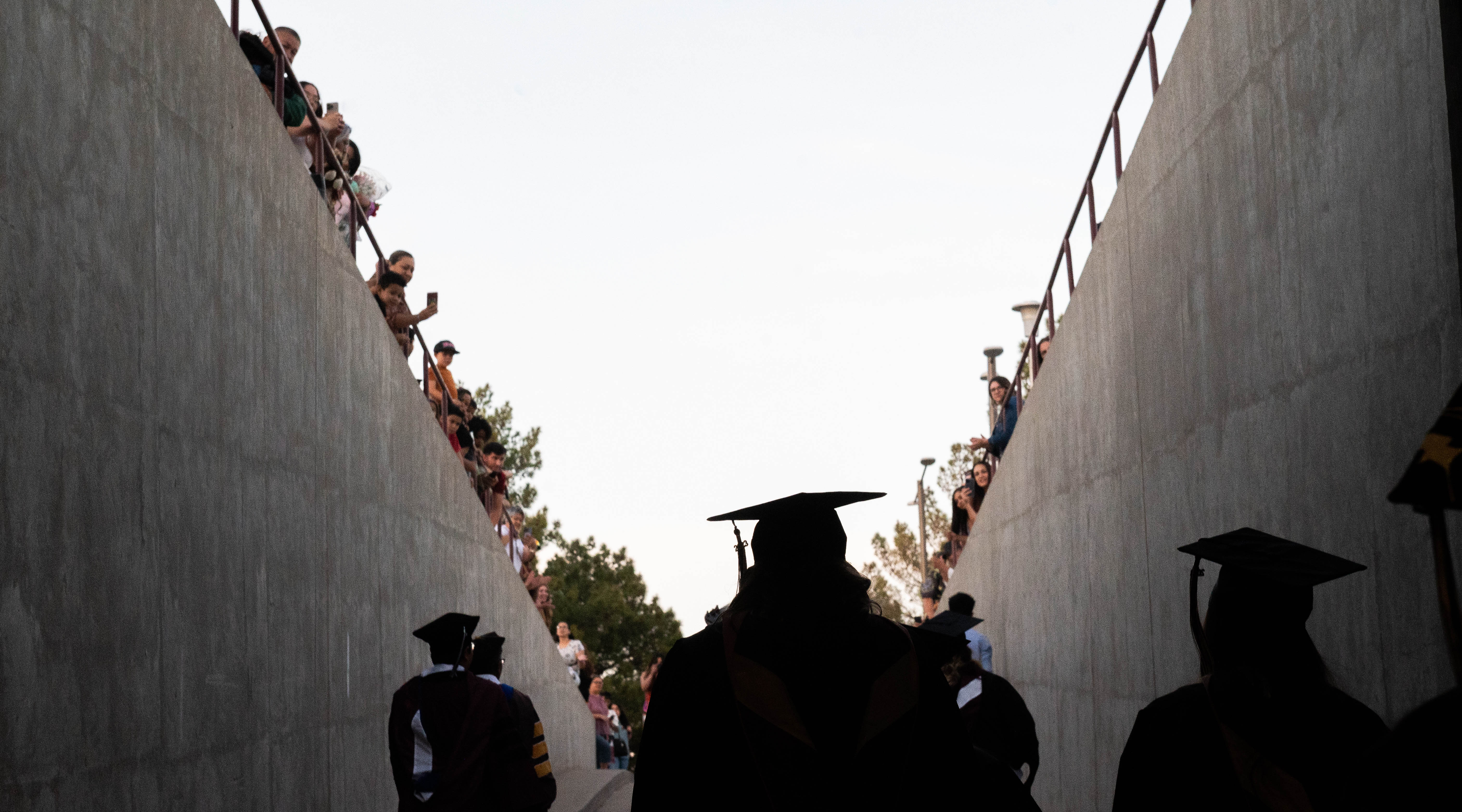 Graduates walk out of the pan American center following the 2023 commencement 