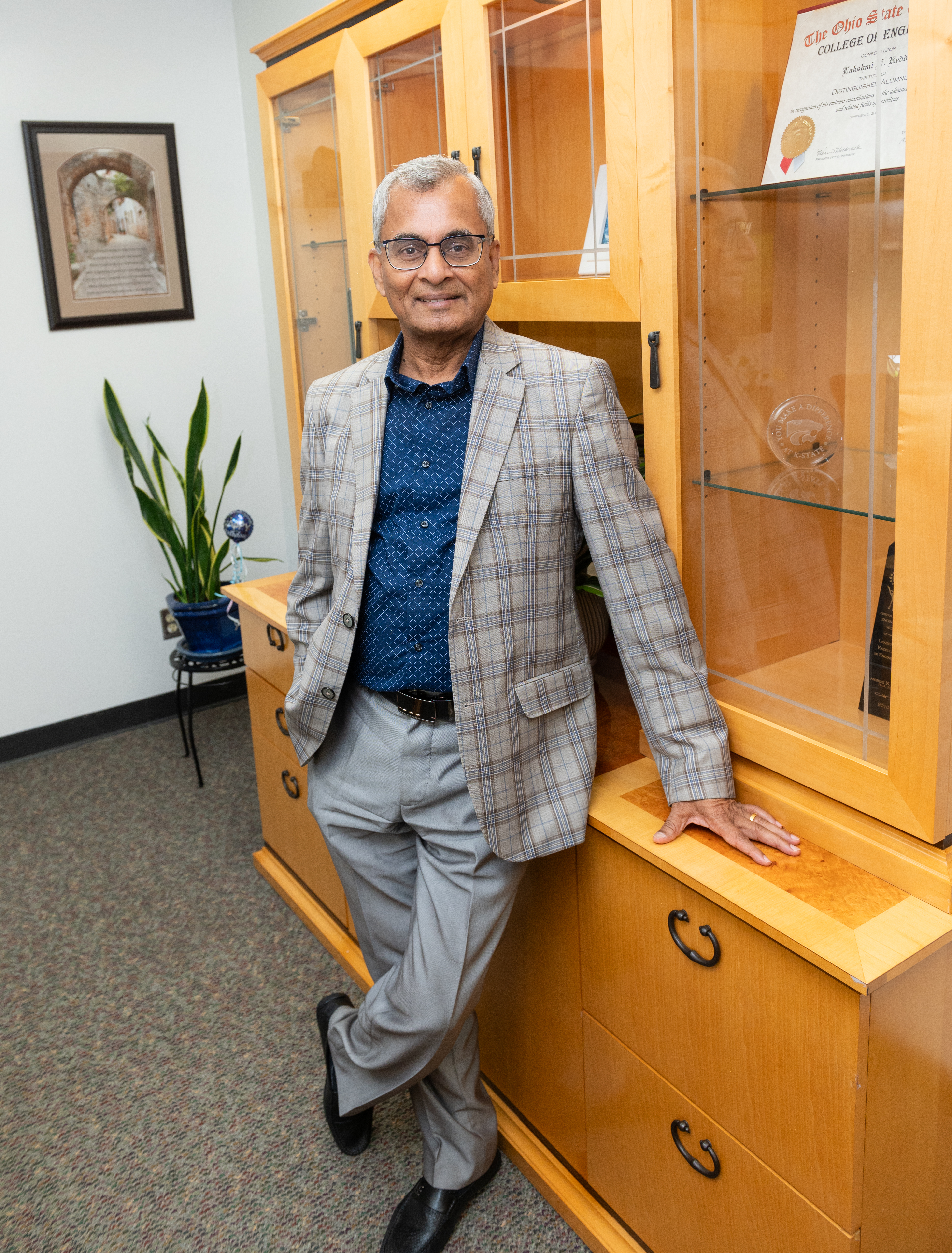 Interim Provost Lakshmi Reddi standing in his office.