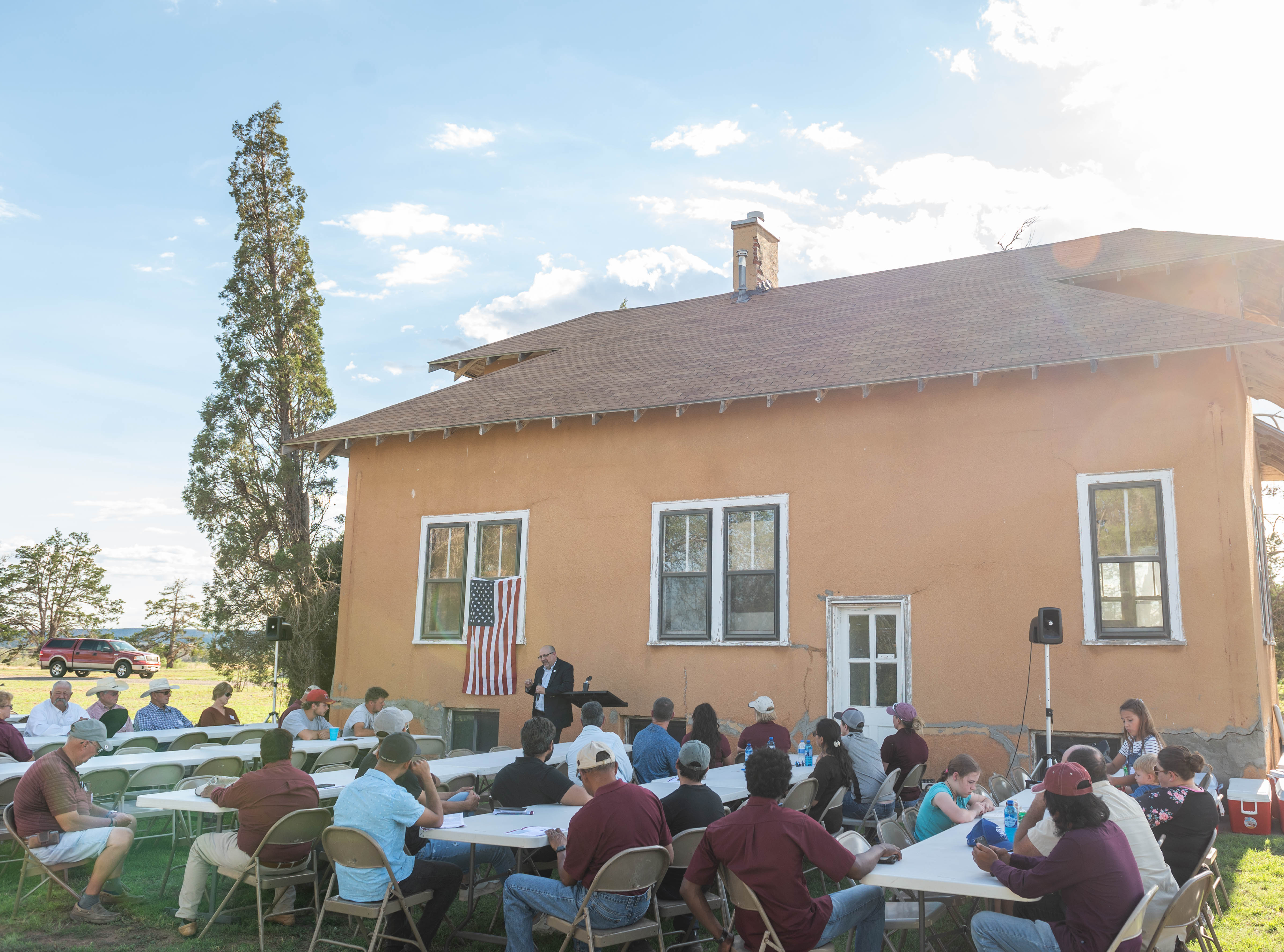 Members of the NMSU community and Tucumcari area gather around tables during the Augus 2022 Tucumcari Field Day. 