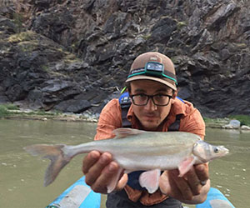 Photo of Giulio del Piccolo holding a fish. 