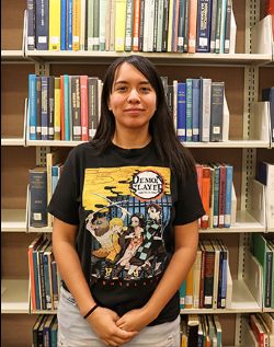 Photo of America Caballero in front of library books